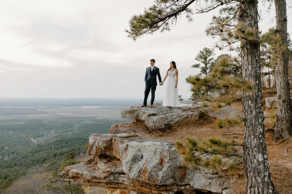 best places to elope in arkansas bride and groom holding hands with scenic view in background-- best places to elope in arkansas