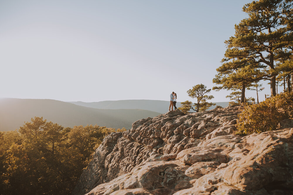 man and woman embracing with scenic backdrop-- arkansas elopement locations