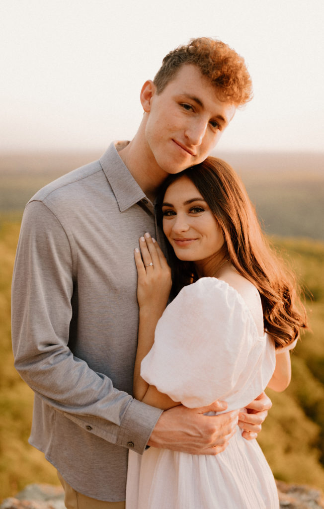 man and woman hugging and looking at camera-- arkansas elopement photography white rock