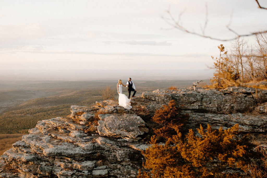 Couple standing on mountaintop during adventure arkansas 
elopement at Mount Magazine in Arkansas
